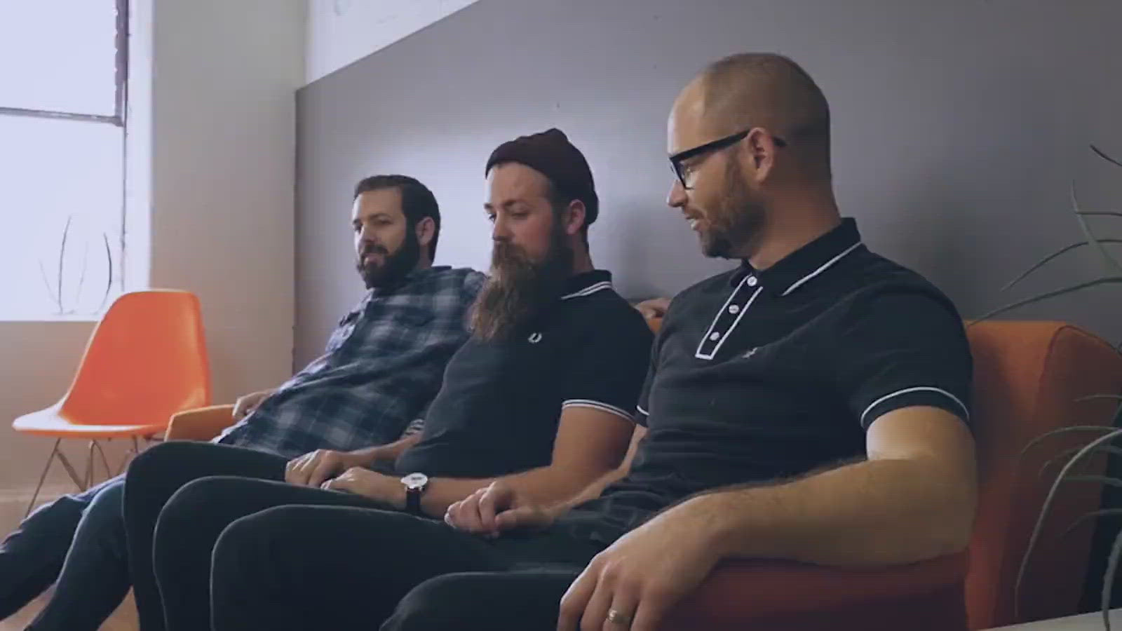 Load video: Several Vidlogix employees make room for their colleague on a sofa.